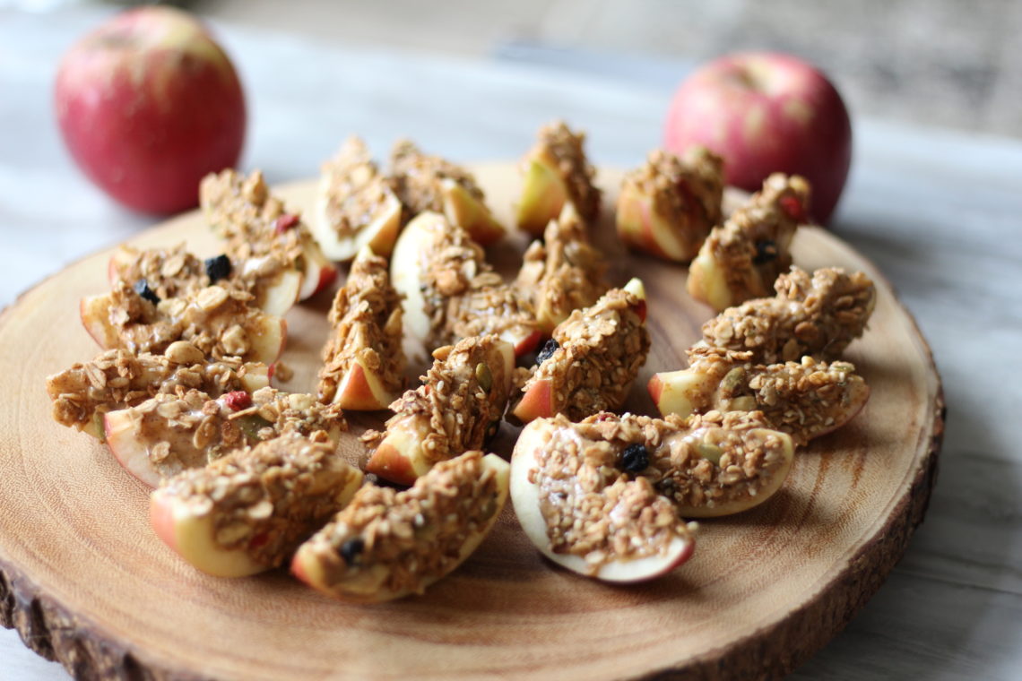 Apple slices in a snack container with an individual almond butter dipping packet
