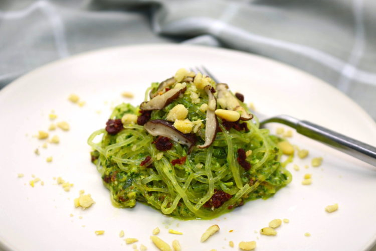 Kelp noodles with vegan pesto topped with pine nuts